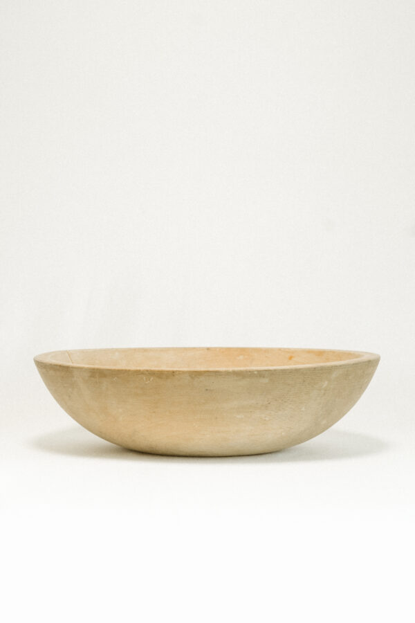 tan colored wooden bowl against white background