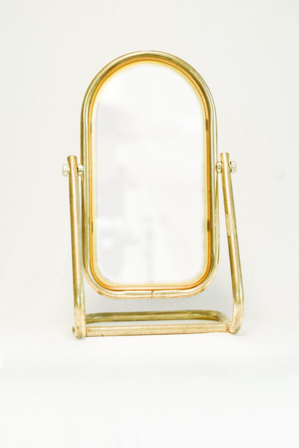 antique brass mirror against white background