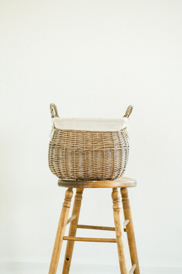 wicker basket resting on wooden stool