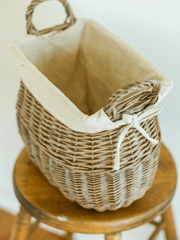 wicker basket resting on wooden stool